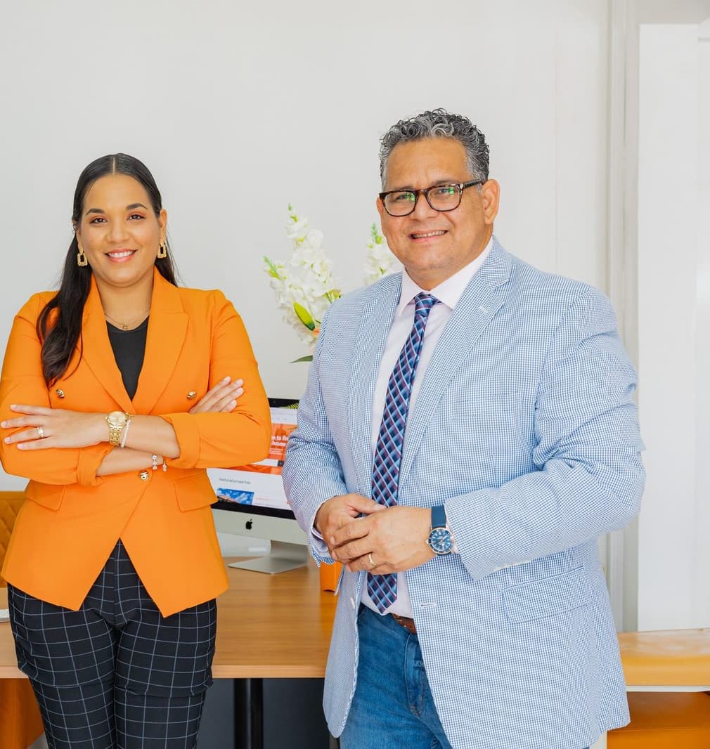The Objective Realty team standing together in their Aruba office